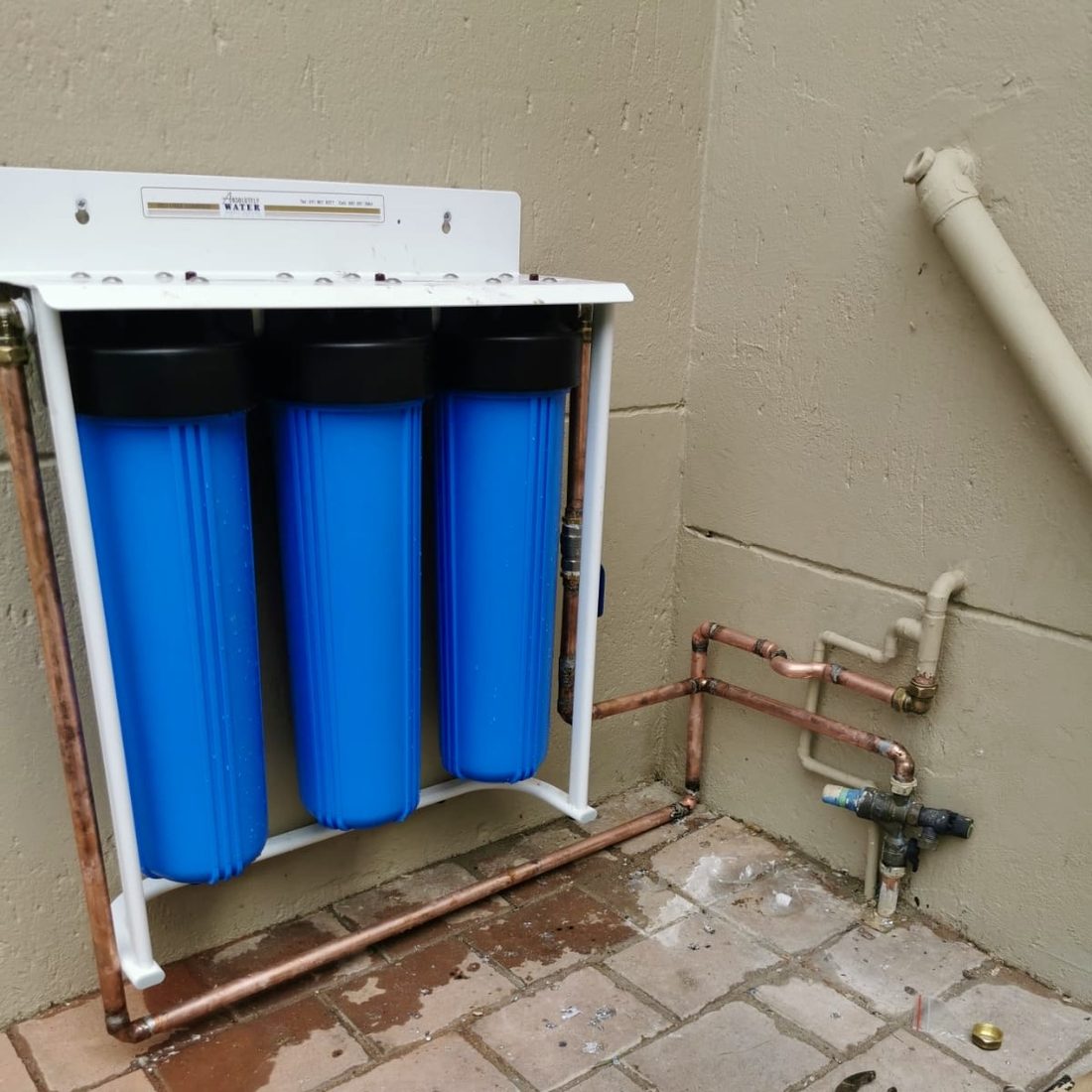 Whole house Big Blue filtration system connected with copper plumbing