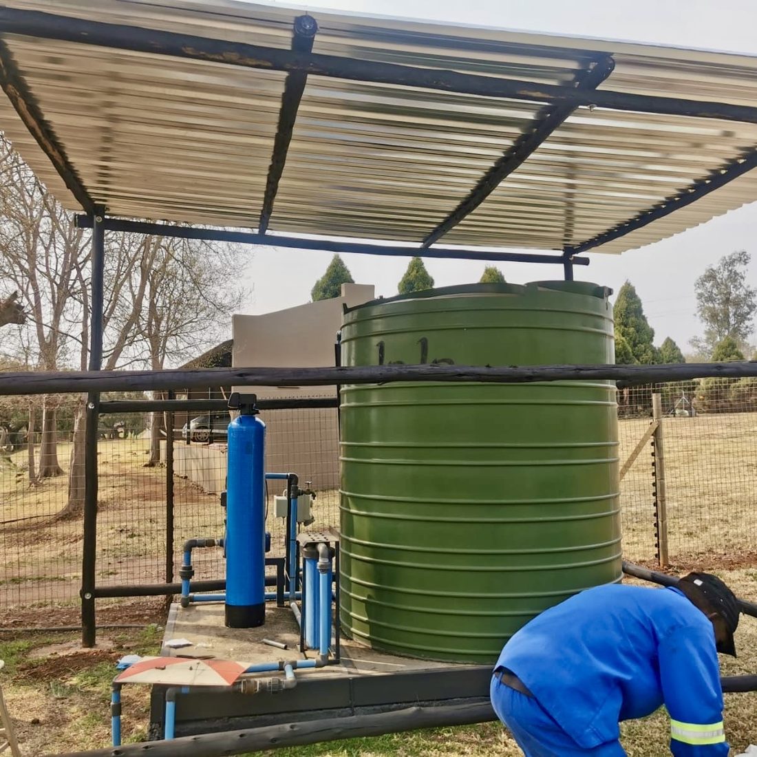 Custom treatment installation in progress beside a JoJo tank